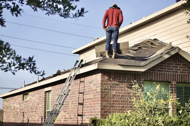 Professional roofer working on a residential roof in Empire Estates